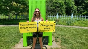 A woman holding motivational gym quotes in East Brunswick, NJ
