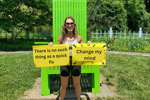 A woman holding motivational gym quotes in East Brunswick, NJ